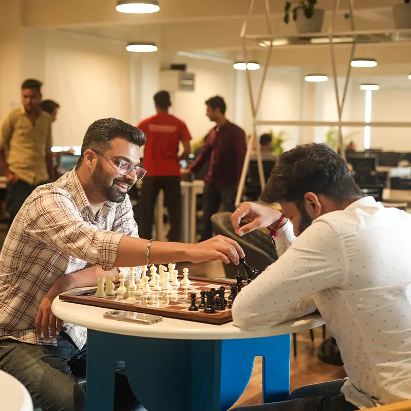 Coworkers playing chess at PNP Cafeteria